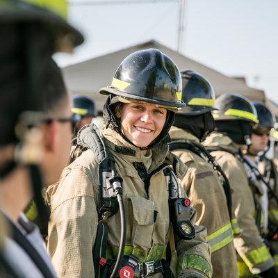 Firefighter in uniform with colleagues.
